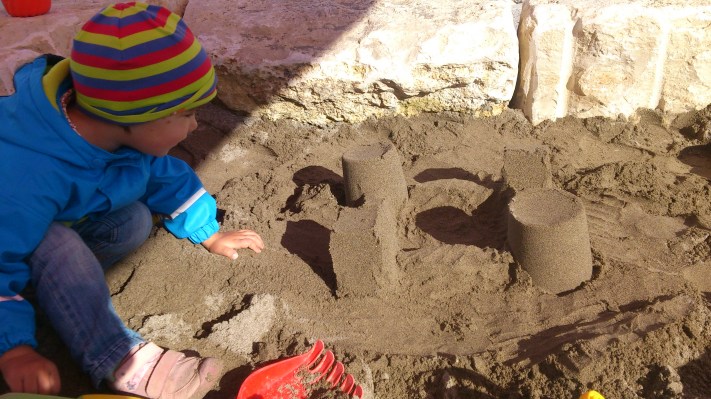 Sand castle - just discovered by the little one and still unaware of the danger it is currently in.. (lurking in the shadows)